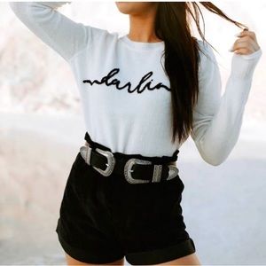 Kittenish Darling white with black cursive spell out letters sweater